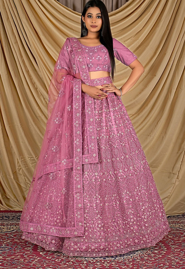 Woman wearing a pink traditional outfit with a pink dupatta