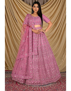 Woman wearing a pink traditional outfit with a pink dupatta
