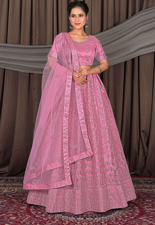 Woman wearing a pink traditional outfit with a dupatta