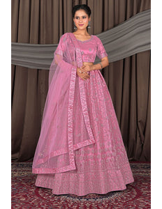 Woman wearing a pink traditional outfit with a dupatta