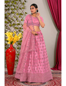 Woman in a pink traditional lehenga choli with dupatta