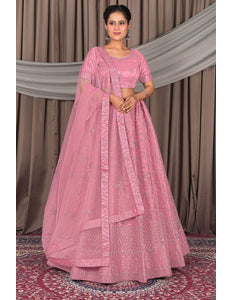Woman wearing a pink traditional outfit with a matching dupatta