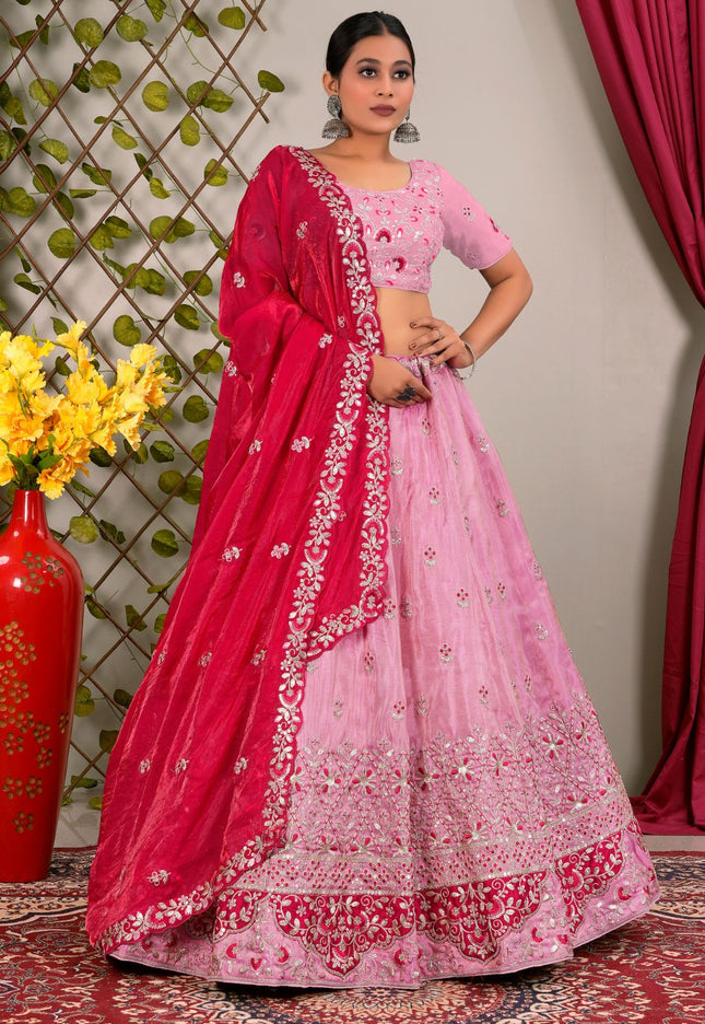 Woman wearing a pink and red traditional lehenga choli