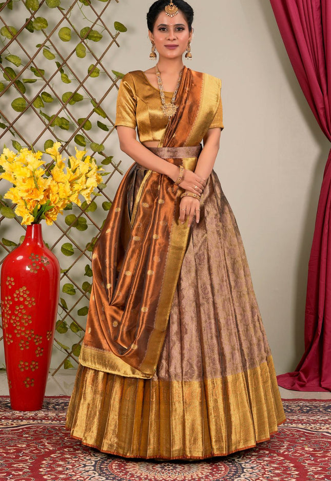 Woman in a traditional gold and brown lehenga choli with dupatta