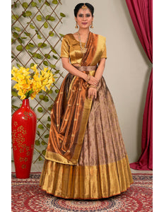 Woman in a traditional gold and brown lehenga choli with dupatta