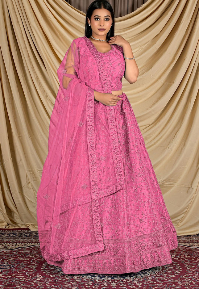 Woman wearing a pink traditional outfit with a matching dupatta