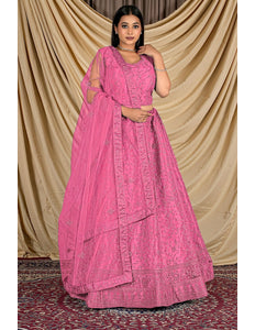 Woman wearing a pink traditional outfit with a matching dupatta