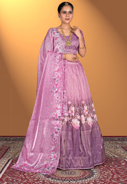 Woman wearing a pink lehenga choli with floral patterns