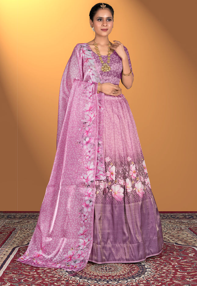 Woman wearing a pink lehenga choli with floral patterns