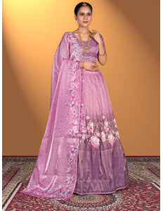 Woman wearing a pink lehenga choli with floral patterns