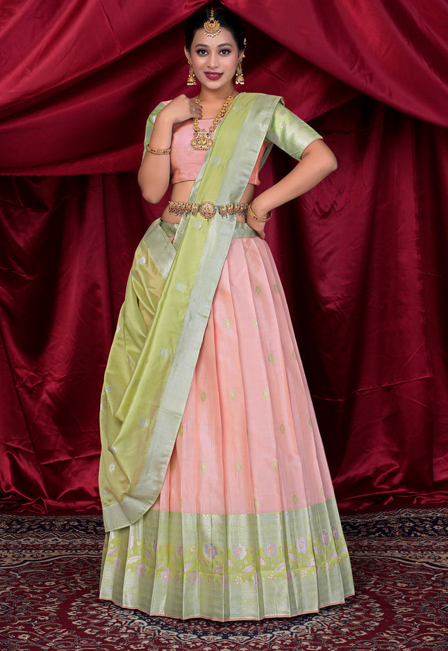 Woman wearing a pink and green lehenga choli