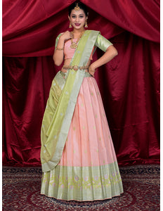Woman wearing a pink and green lehenga choli