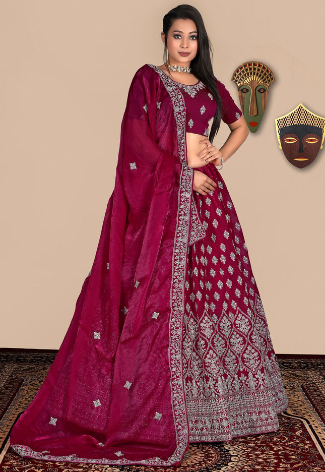 Woman wearing a pink lehenga choli with white patterns
