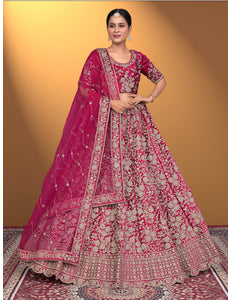 Woman wearing a traditional pink embroidered outfit with a matching dupatta