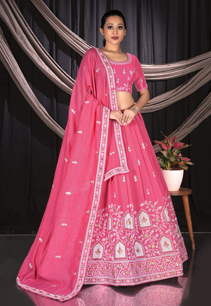 Woman wearing a pink traditional outfit with white patterns