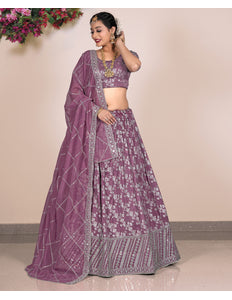 Woman wearing a purple traditional outfit with floral patterns