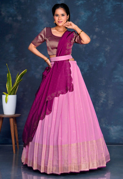 Woman in a pink and purple traditional lehenga choli with dupatta