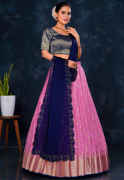 Woman wearing a traditional outfit with a dark blue and pink skirt