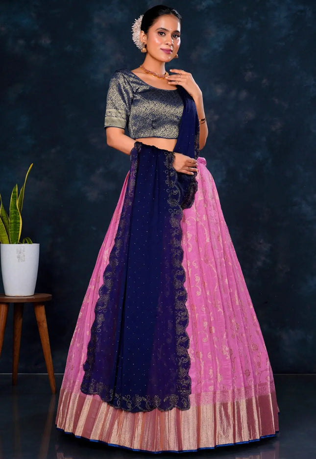 Woman wearing a traditional outfit with a dark blue and pink skirt