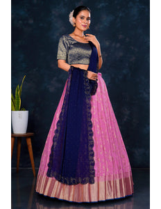 Woman wearing a traditional outfit with a dark blue and pink skirt