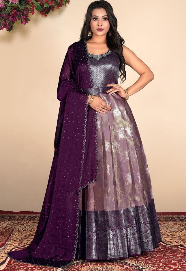 Woman wearing a purple traditional outfit with a matching dupatta