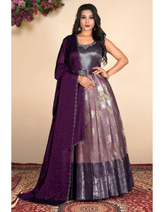 Woman wearing a purple traditional outfit with a matching dupatta