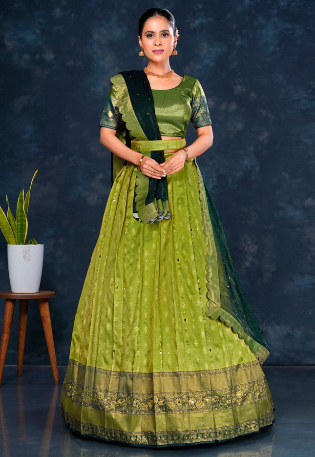 Woman wearing a green traditional half saree with dupatta