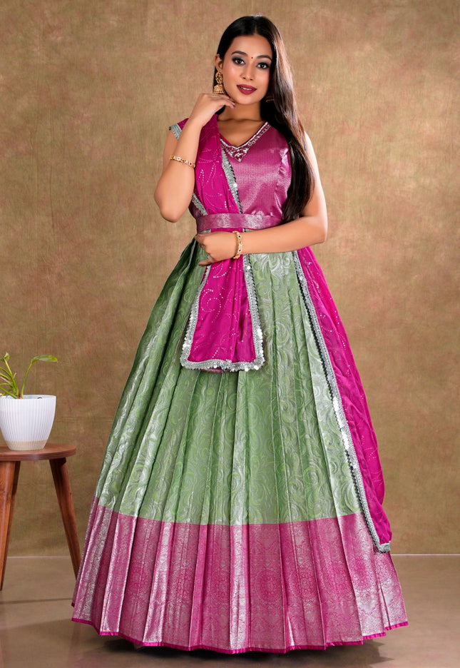 Woman wearing a green and pink traditional gown with dupatta