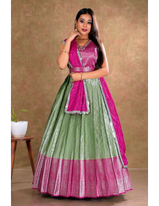 Woman wearing a green and pink traditional gown with dupatta