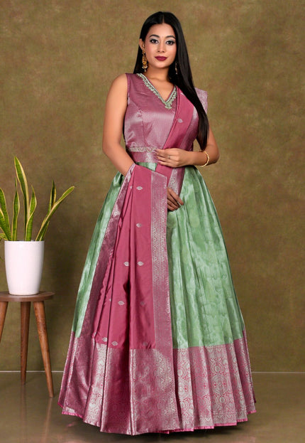 Woman wearing a pink and green gown with dupatta