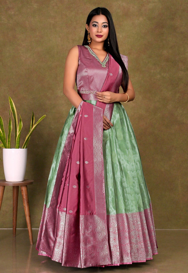 Woman wearing a pink and green gown with dupatta