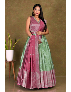 Woman wearing a pink and green gown with dupatta