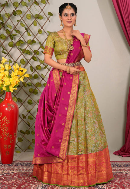 Woman wearing a traditional green and pink lehenga choli with dupatta