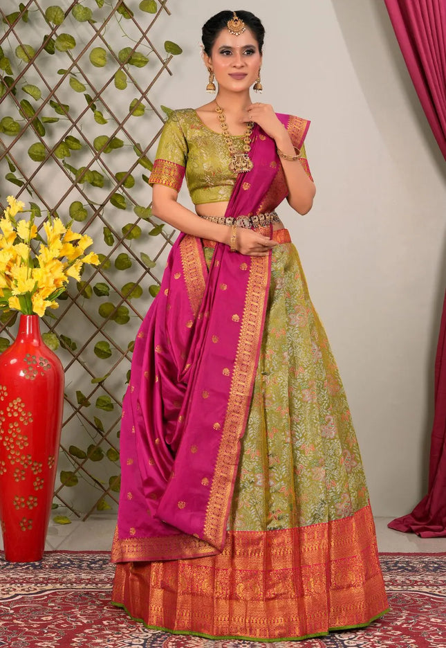 Woman wearing a traditional green and pink lehenga choli with dupatta