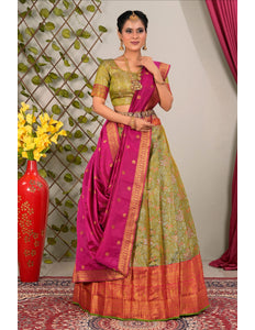 Woman wearing a traditional green and pink lehenga choli with dupatta