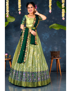 Woman in a green and light green lehenga choli with dupatta