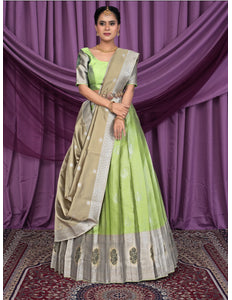 Woman wearing a green and beige lehenga choli
