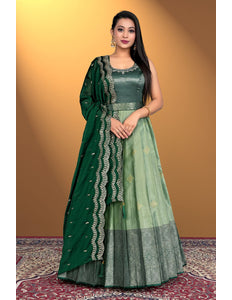 Woman wearing a green traditional outfit with a matching dupatta