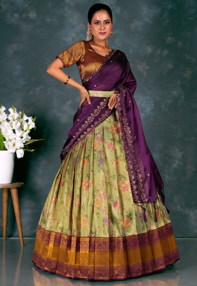 Woman wearing a traditional outfit with a purple blouse and green skirt