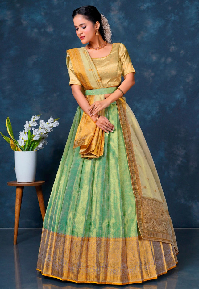 Woman in a green and yellow traditional lehenga choli with dupatta