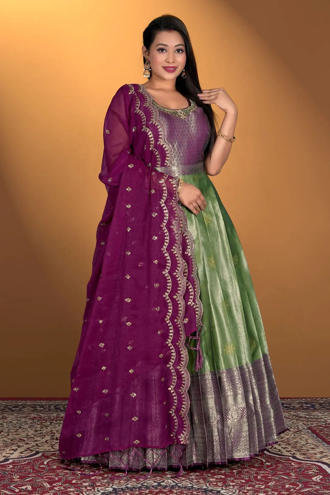Woman wearing a purple and green gown with dupatta