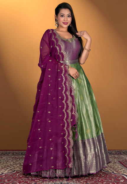 Woman wearing a purple and green gown with dupatta