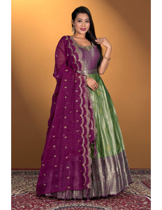 Woman wearing a purple and green gown with dupatta