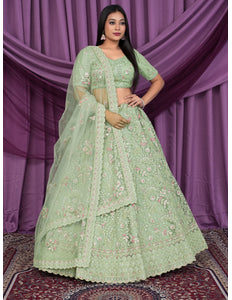 Woman wearing a light green embroidered lehenga choli