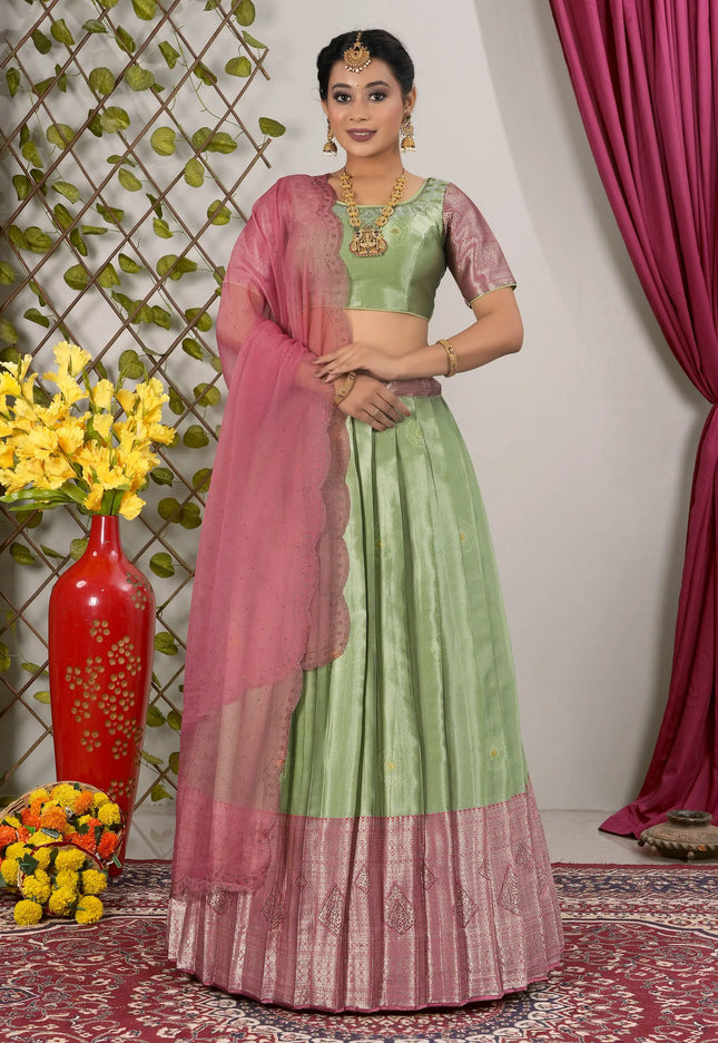 Woman in a green and pink traditional lehenga choli with dupatta
