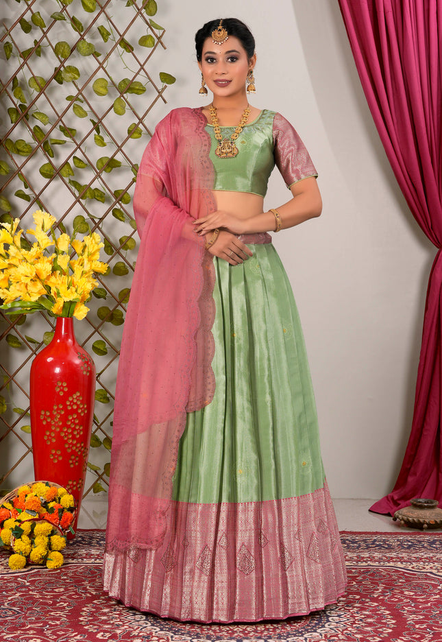 Woman in a green and pink traditional lehenga choli with dupatta