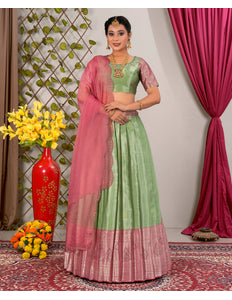 Woman in a green and pink traditional lehenga choli with dupatta