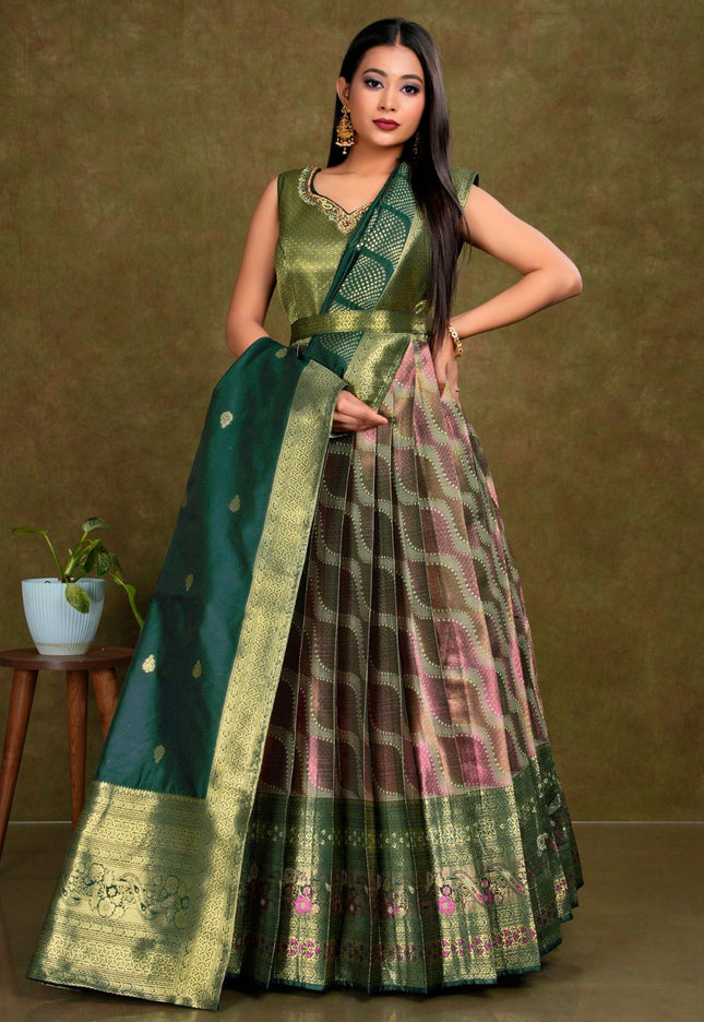 Woman wearing a green gown with a patterned design