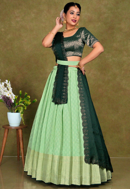 Woman wearing a green and Pista traditional outfit
