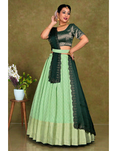 Woman wearing a green and Pista traditional outfit